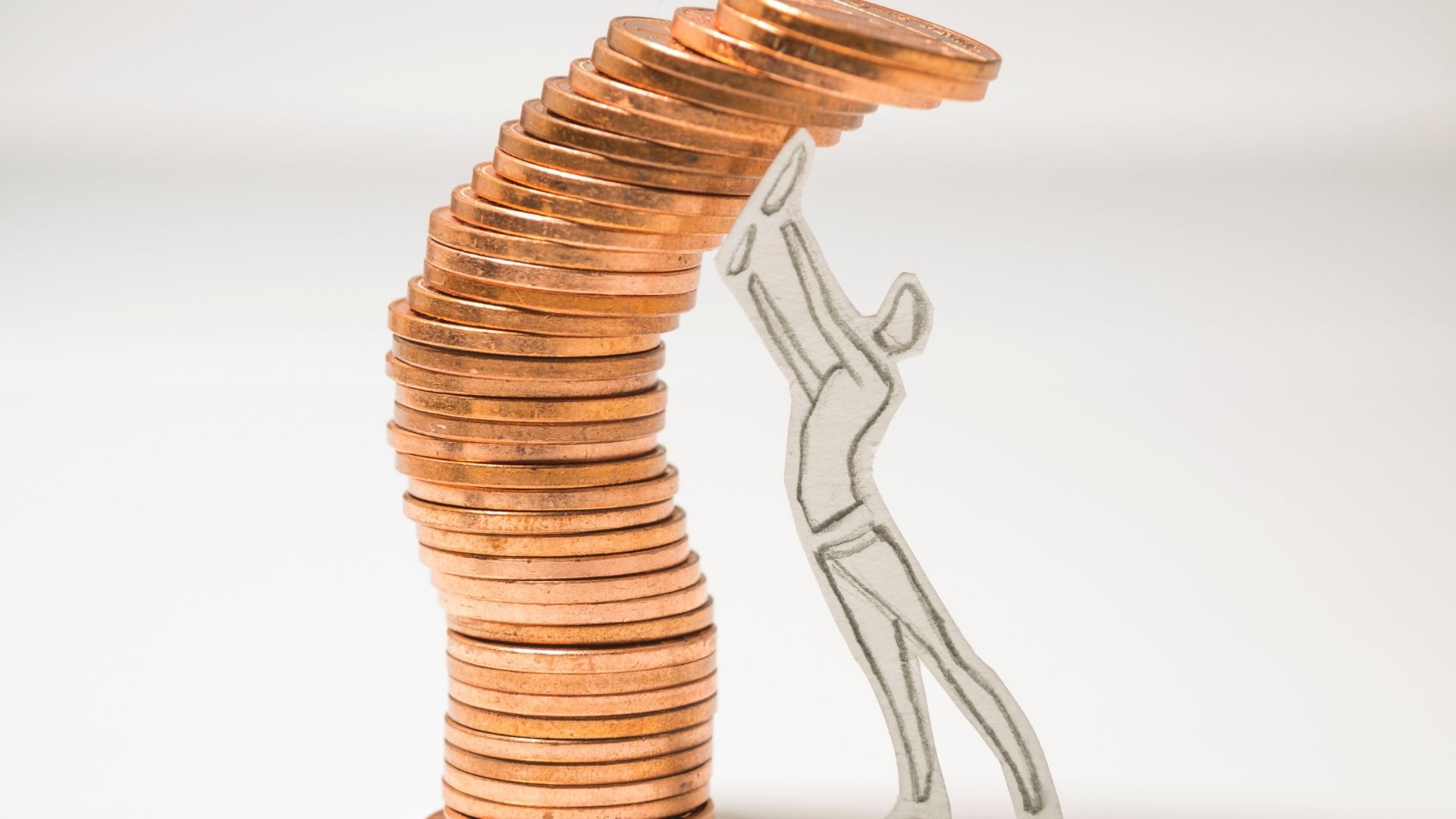 home financing in michigan stick person holding a stack of pennies upright