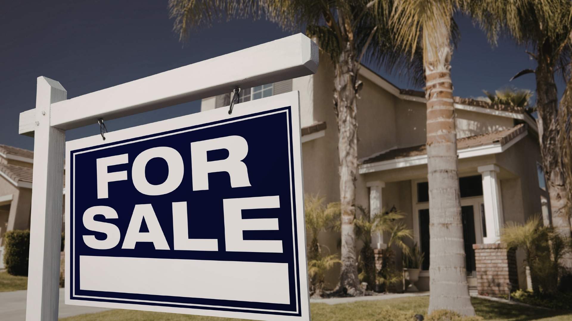 blue for sale sign in front of tropical home location