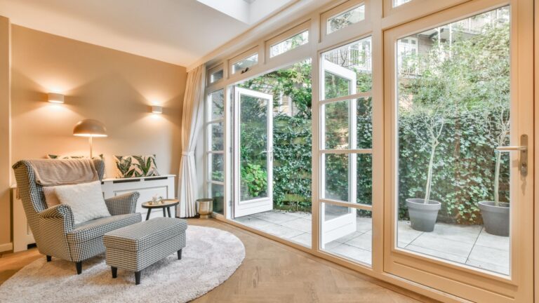 interior of home with large windowed doors and black and white chair next to it